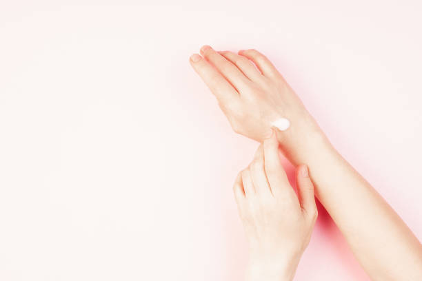 istock Woman moisturizing her hand with cosmetic cream 1221389742