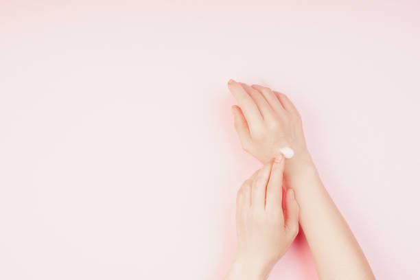 istock Woman moisturizing her hand with cosmetic cream 1221389743