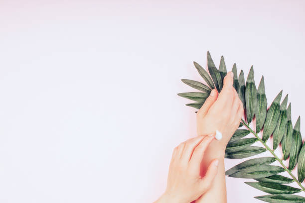 istock Woman moisturizing her hand with cosmetic cream 1221389745