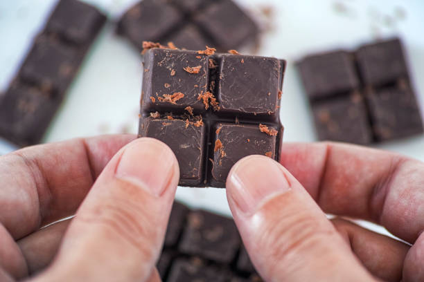 istock Man holding homemade dark chocolate in his hands 1221389800