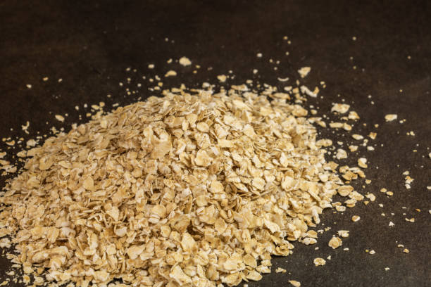 pile of oatmeal on a black background stock photo
