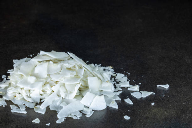 Close-up on a bunch of white coconut chips on a black background stock photo