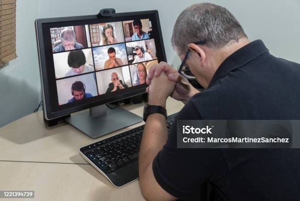 Friends In Their Homes On A Conference Call And Praying Together For The Good Of All Lowering The Head Stock Photo - Download Image Now