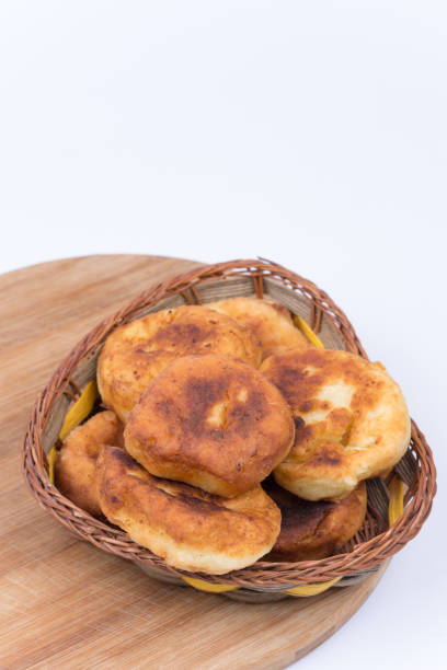 istock Donuts in the wooden basket over white background 1221394994
