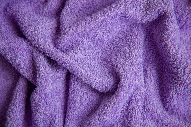 istock Purple Terry cloth or towel in a fold, close-up. Textile background. 1221395211