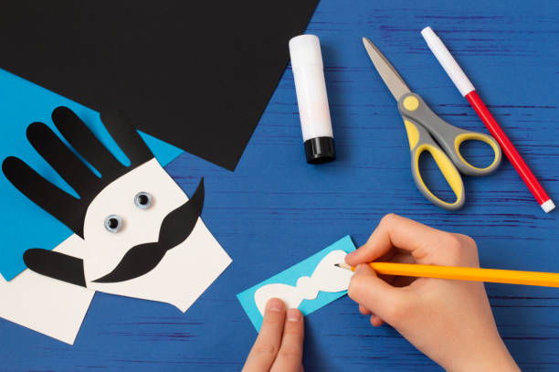 istock Child makes card for Father's Day. Step 10 1221395741