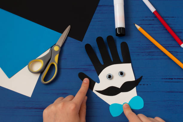 istock Child makes card for Father's Day. Step 12 1221395800