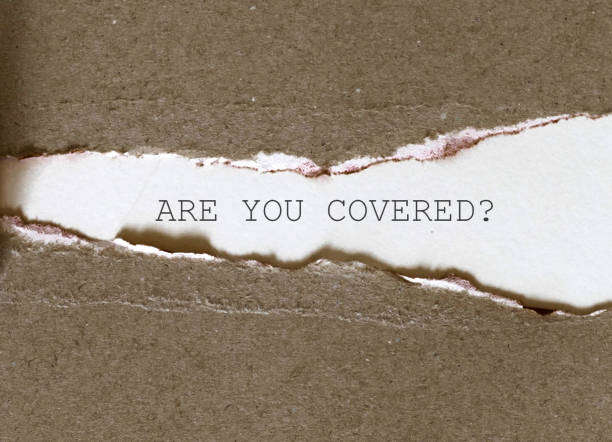 the words are you covered? typed on a scrap of lined paper and pinned to a cork notice board. asking the question, are you insured for your car, travel, home or other liability. - fine print imagens e fotografias de stock