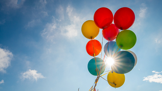 Multicoloured balloons against blue sky