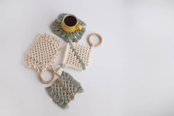 istock Boho coasters with hot tea and green leaves, isolated white background 1221398682
