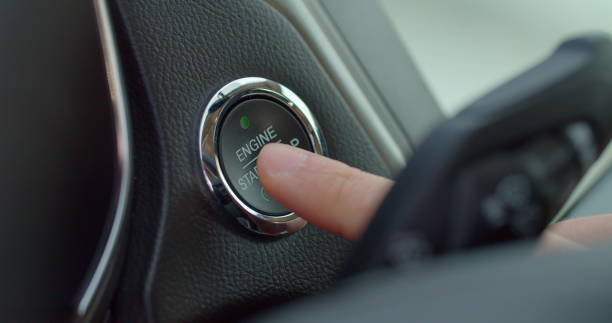 istock Starting car engine. Track in to the button. Finger press the button to start the car engine. 1221399047