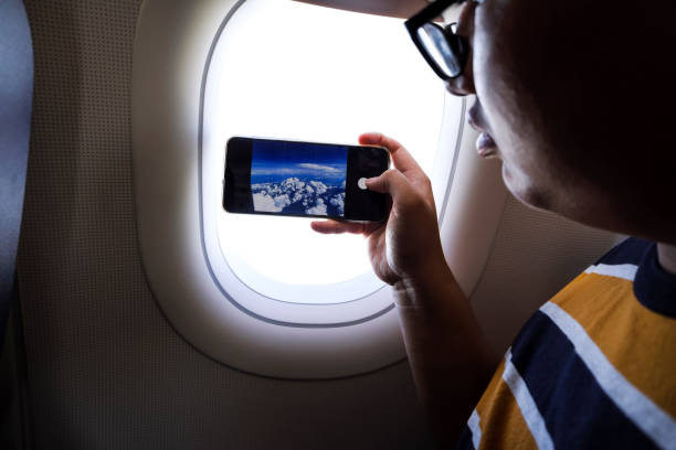 istock Young passenger using smartphone on board a commercial airplane 1221400748