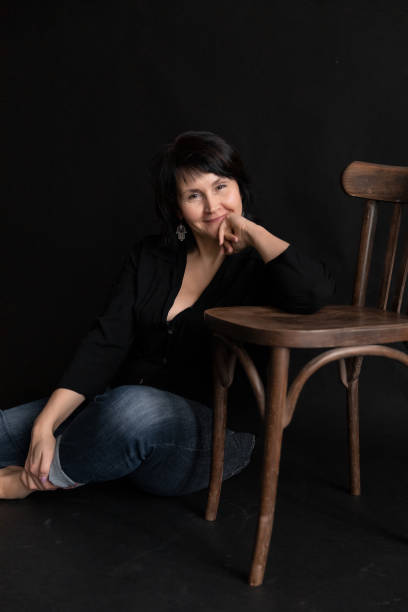 istock Pensive Woman Middle-aged Brunette in Dark Interior 1221401323