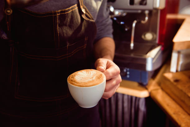Coffee Latte Barista making pattern in a cup of coffee shop.
