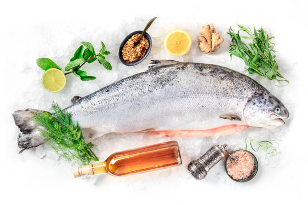 istock Fresh salmon, shot from above on a white background with various condiments and wine 1221403000