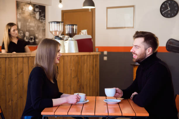 istock Young couple talking in a coffee shop 1221403976
