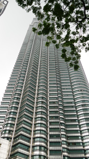 Cropped upward shot of one of the Twin Petronas Towers in Kuala Lumpur, Malaysia.