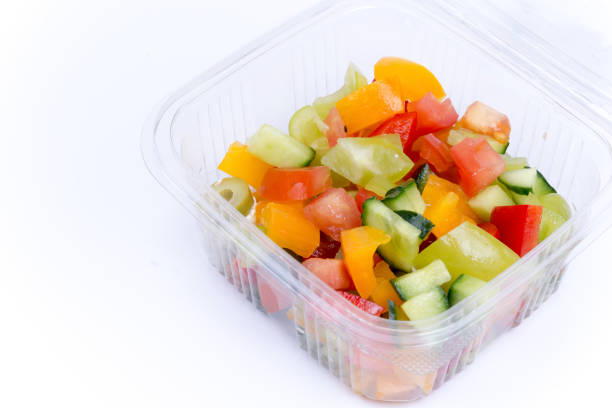 istock Greek salad in plastic box isolated over white 1221404430
