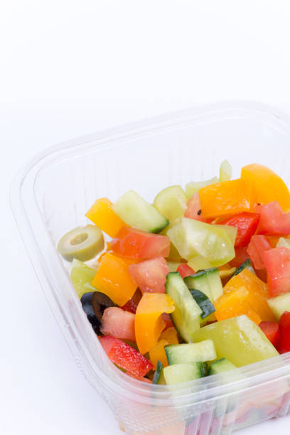 istock Greek salad in plastic box isolated over white 1221404439