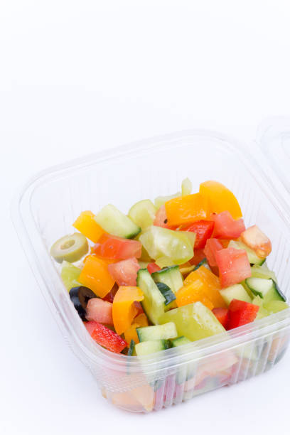 istock Greek salad in plastic box isolated over white 1221404463