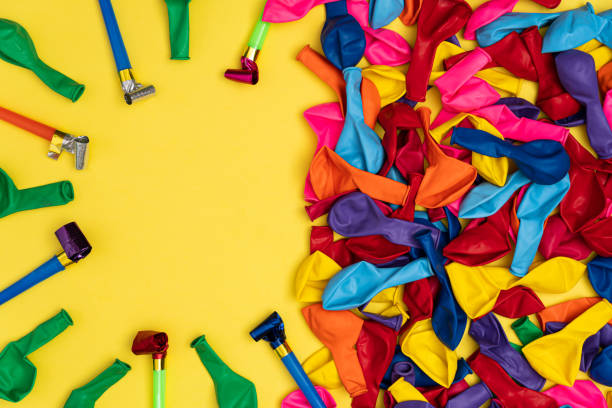 istock Multicolor whistles and colorful balloons, top view 1221404678