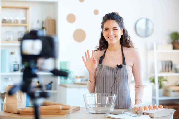 istock Young Woman Greeting Followers 1221405147