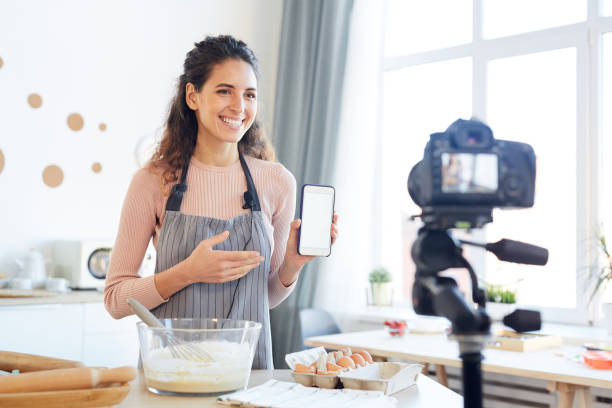 istock Food Vlogger Demonstrating Smartphone App 1221405166