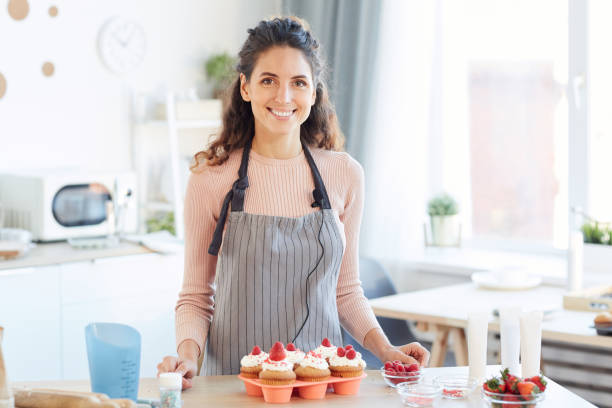 istock Happy Woman With Homemade Cupcakes 1221405238