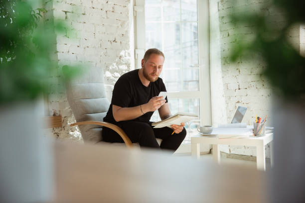 Young man studying at home during online courses for managers, marketers, buyers