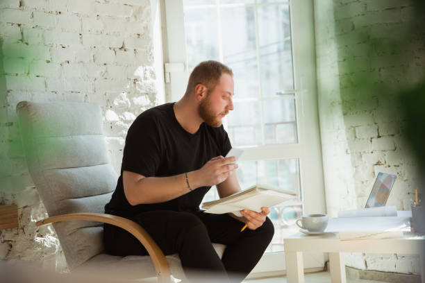 Young man studying at home during online courses for managers, marketers, buyers