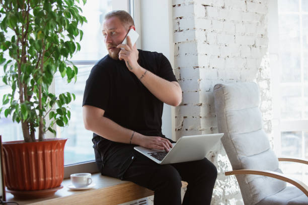istock Young man studying at home during online courses for analytics, financists, economists 1221405958