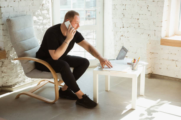 istock Young man studying at home during online courses for analytics, financists, economists 1221405961