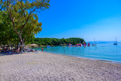 Dassia Beach with crystal clear azure water in beautiful landscape scnery - paradise coastline of Corfu island, Ionian archipelago, Greece.