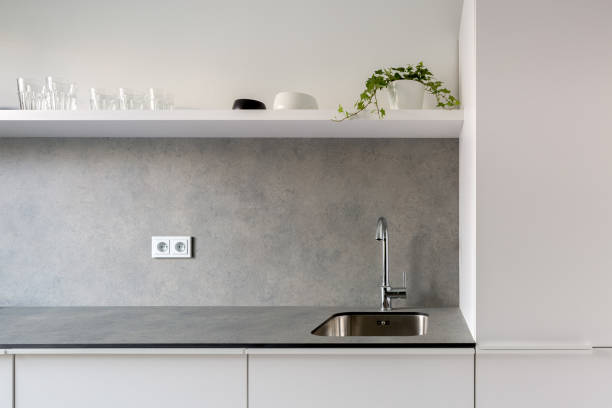istock Simple kitchen sink in gray countertop 1221406908