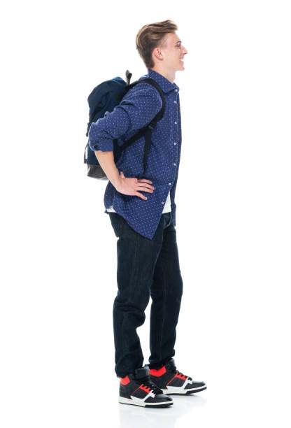 istock Caucasian boys standing in front of white background wearing jeans 1221407245