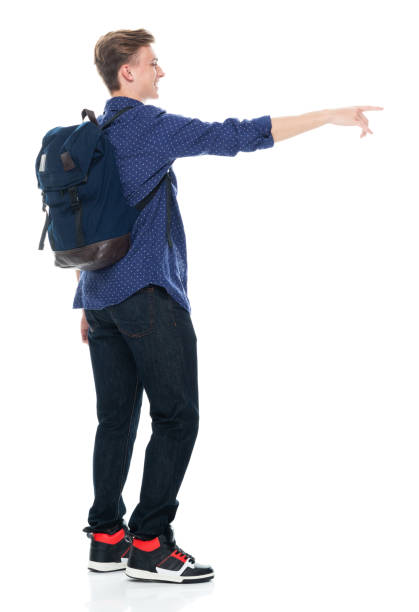 istock Caucasian boys standing in front of white background wearing jeans 1221408403