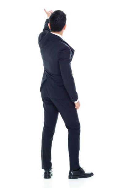 Rear view of aged 20-29 years old chinese ethnicity young male presenter standing in front of white background who is overworked who is showing with hand presenting
