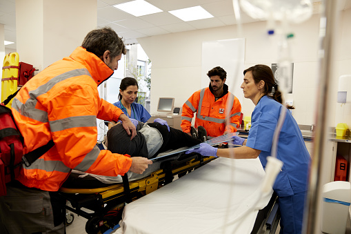 The nurse prepares the monitoring equipment as they anticipate the arrival of their trauma patient.