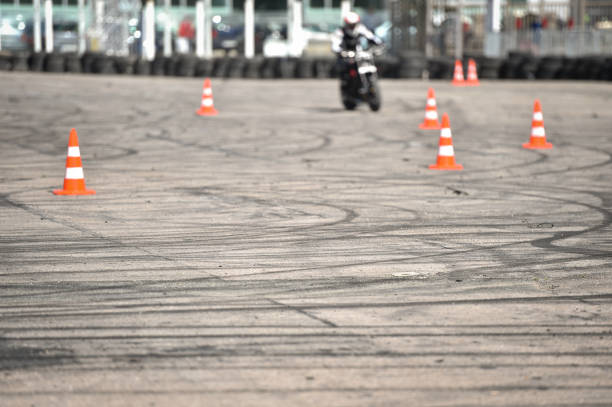 istock Drift traces and traffic cones and a motorcycle practicing in the background 1221410347