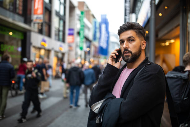 istock Businessman standing on pedestrian street and using phone 1221410535