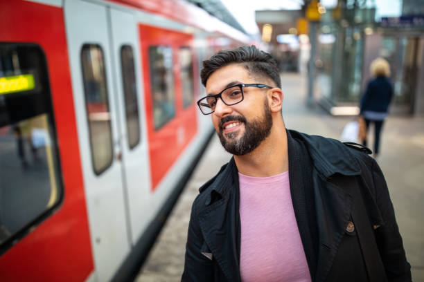 istock Businessman waiting for a train at railroad station 1221411522
