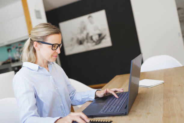 istock pretty young woman doing home office 1221411532