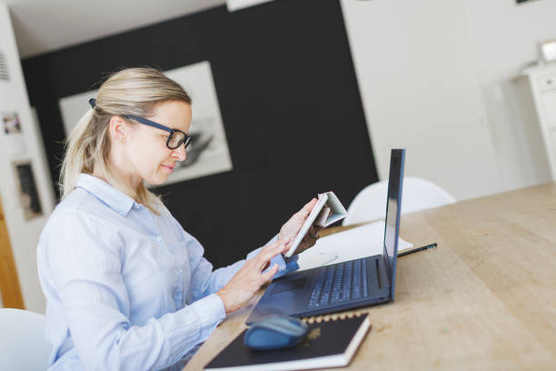 istock pretty young woman doing home office 1221411567