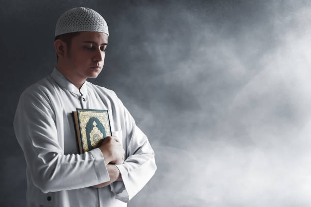 istock Religious asian muslim man holding holy quran 1221412666