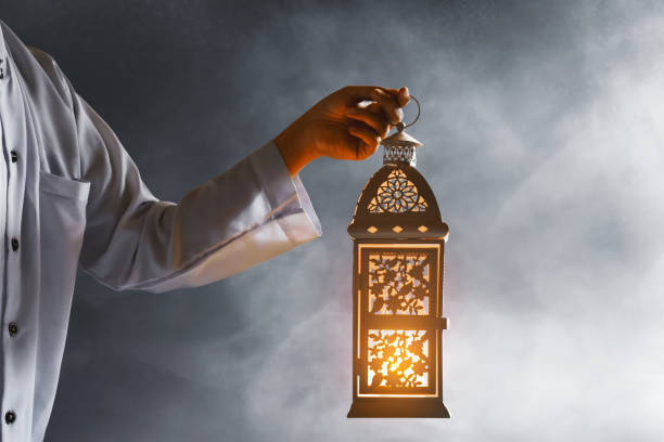 istock Muslim man holding arabic lantern, Ramadan kareem background 1221412672