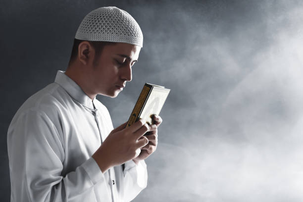 istock Religious asian muslim man holding holy quran 1221412675