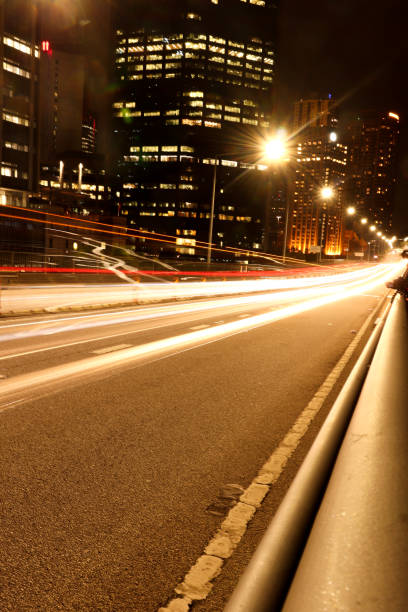 istock Car light trail shot at night in city centre 1221414619