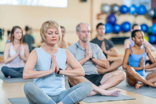 istock Group of yoga enthusiasts 1221415605
