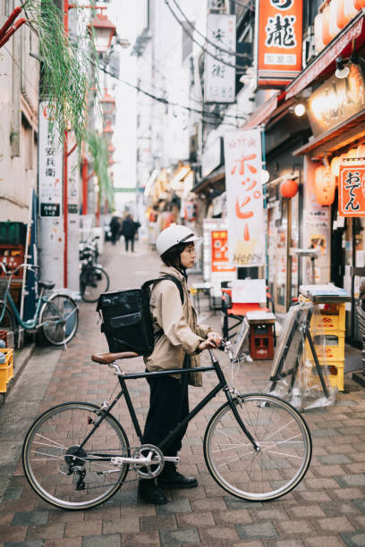 istock Bike Messenger Waiting In Front Of A Restaurant 1221418320