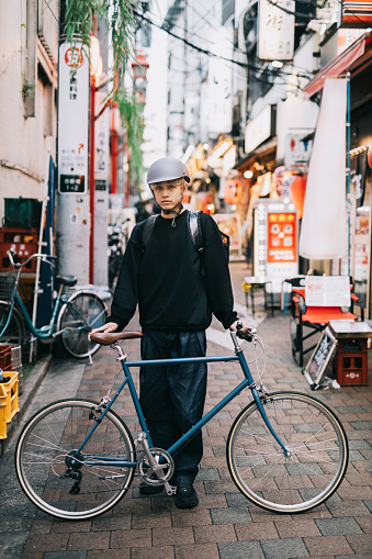 Full length Portrait of a Bike Messenger Delivering Food.
